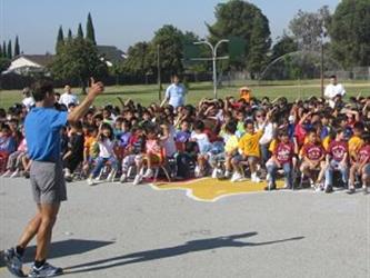 A PE teacher giving a thumbs up to a group of students